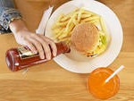 pouring ketchup on plate